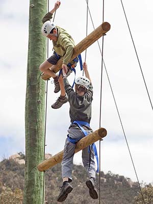 Students climbing up the vertical ropes