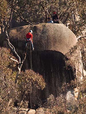 Students abseiling down a rockface